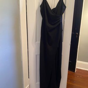 Long black dress. Slit to upper thigh.